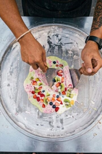 Thai rolled ice cream being freshly prepared on a cold plate