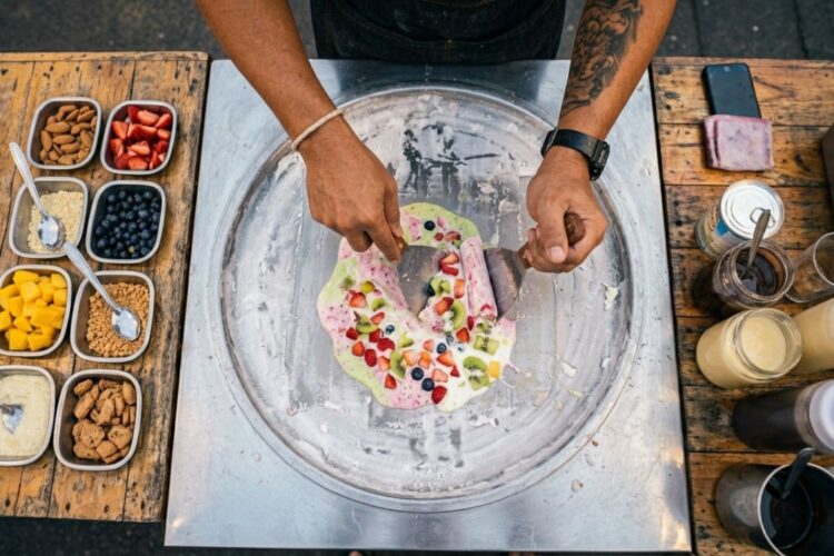 Thai rolled ice cream being freshly prepared on a cold plate
